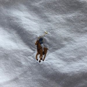 Two Ralph Lauren polo oxford long sleeve shirts.